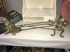 A set of brass ball & claw fire irons & dogs