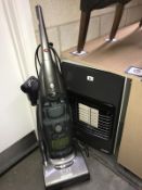 A gas space heater and a hoover vacuum cleaner