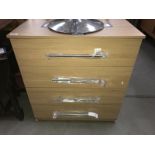 A modern 4 drawer chest of drawers on castors