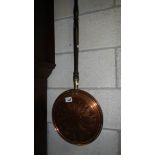 An old copper warming pan,.