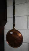 An old copper warming pan,.