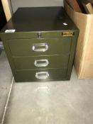 A small 3 drawer metal cabinet (locked)