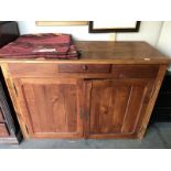 A pine cupboard with single drawer