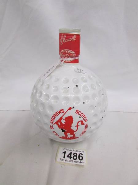 A sealed bottle of St. Andrews golf ball whisky.