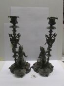 A pair of cast metal continental candlesticks.