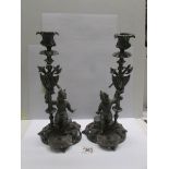 A pair of cast metal continental candlesticks.