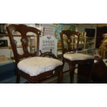 A pair of mahogany bedroom chairs.