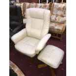 A cream coloured leather executive armchair & foot stool