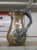 A 'Toff Millway' pottery jug decorated with fish and with fish handle.