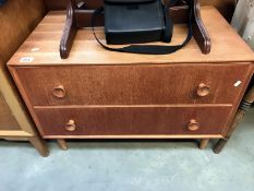 A teak chest of 2 drawers on tapering legs