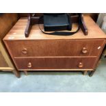 A teak chest of 2 drawers on tapering legs