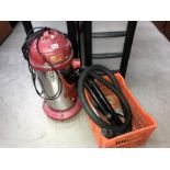 A Readyvac standing cylinder vacuum cleaner