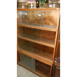 A Globe Wernicke style 4 tier bookcase with glass sliding doors made by Minty Ltd.