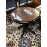 A round pedestal table with cloved hoof carved feet