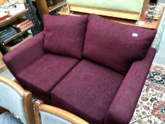 A peep red upholstered 2 seater sofa