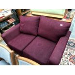 A peep red upholstered 2 seater sofa