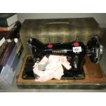 A boxed Federation hand-cranked sewing machine