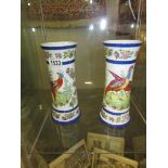 A pair of exotic bird decorated vases.