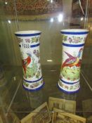 A pair of exotic bird decorated vases.