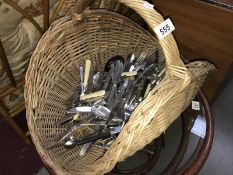 A basket of miscellaneous cutlery