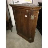 An old oak corner cupboard.