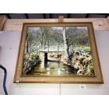 An oil painting of woodland scene with bridge over river signed N.