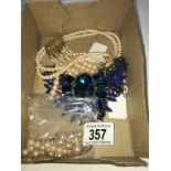 A faux pearl necklace with 2 pairs of earrings and a blue stone necklace