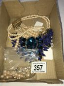 A faux pearl necklace with 2 pairs of earrings and a blue stone necklace