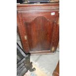 An oak corner cupboard.