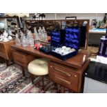 A retro long dressing table with a round leatherette button stool