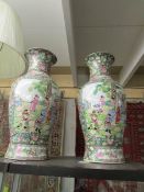 A pair of tall oriental vases .