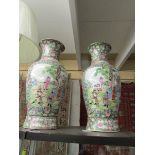 A pair of tall oriental vases .