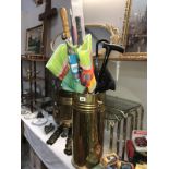 A brass umbrella stand & contents