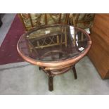 A round glass topped coffee table