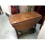 An oval drop leaf table