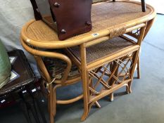 A cane table and 2 chairs