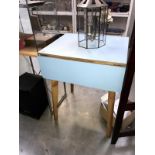 A vintage drop leaf kitchen table