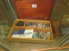 A wooden jewellery box and a large quantity of costume jewellery.