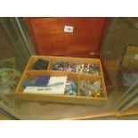 A wooden jewellery box and a large quantity of costume jewellery.