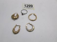 4 odd gold earrings and a silver ring.