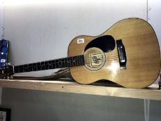 A Hondo II acoustic guitar with leatherette case