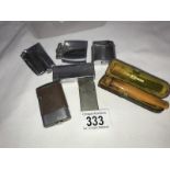 A quantity of cigarette lighters and a cigar holder