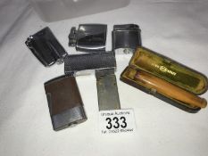 A quantity of cigarette lighters and a cigar holder
