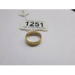 A wide 22ct gold wedding ring, size N.