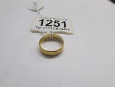 A wide 22ct gold wedding ring, size N.