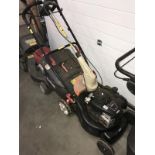 A Briggs & Stratton 125cc lawn mower and garden strimmer