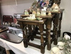 A dark oak nest of tables