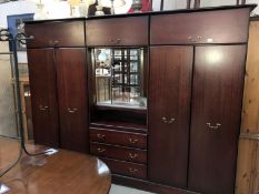 A dark brown bedroom suite including 2 wardrobes and a central dressing section