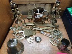 A quantity of brassware including horse brasses and an old brass bell