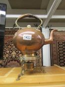 A copper kettle on stand complete with burner.
